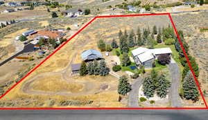 Aerial view of sparsely populated area with property parcel outlined and a desert landscape