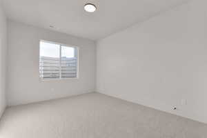 Carpeted empty room with baseboards