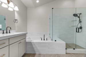 Full bathroom with a garden tub, vanity, a shower stall, and recessed lighting
