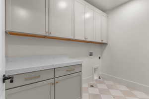 Laundry room featuring washer hookup, electric dryer hookup, and cabinet space