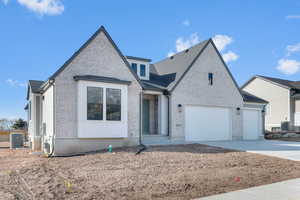View of front of house with brick siding and driveway