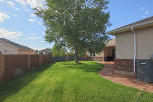 Fenced backyard with a patio