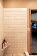 Full bath featuring ensuite bathroom and a tile shower