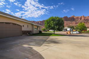 View of patio / terrace featuring driveway, a mountain view, and a garage