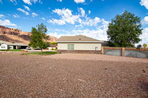 View of side of home with stucco siding, stone siding, and a mountain view