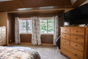 Carpeted bedroom with baseboards
