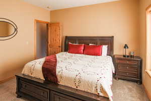 Bedroom featuring light carpet