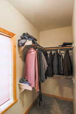 Walk in closet with carpet floors