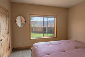 Bedroom with carpet floors and baseboards