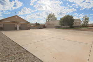 View of front facade with stucco siding and concrete driveway