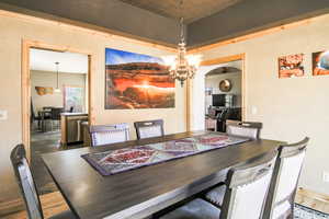 Dining area with a chandelier and wood finished floors