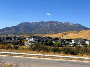 View of mountain backdrop featuring nearby suburban area