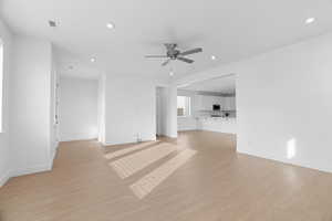 Unfurnished living room with recessed lighting, light wood-style floors, and ceiling fan