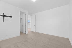 Unfurnished room featuring carpet floors and baseboards