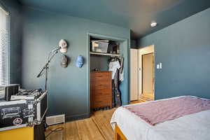 Bedroom with light wood-type flooring and a closet