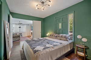 Bedroom featuring dark wood finished floors and a textured ceiling