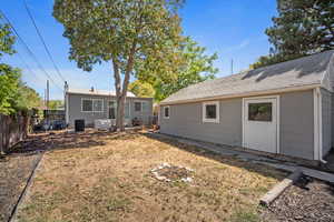Rear view of house with a shingled roof