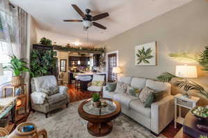 Living area with wood finished floors and ceiling fan