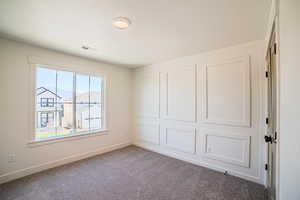 Unfurnished bedroom with baseboards and carpet