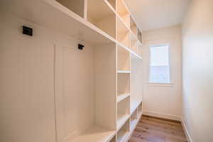 Mudroom featuring light wood-type flooring and baseboards
