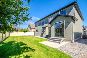 Back of property featuring a fenced backyard, stucco siding, and a patio
