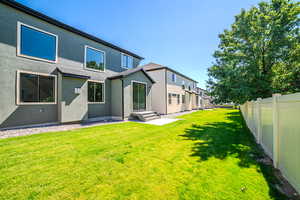 Rear view of property with stucco siding and a patio