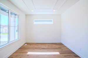 Empty room with light wood-type flooring and recessed lighting