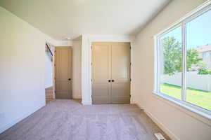 Unfurnished bedroom featuring carpet flooring and a closet
