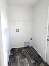 Laundry area with dark wood-style flooring, hookup for a washing machine, a heating unit, and electric dryer hookup