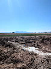 View of mountain backdrop with rural landscape and abundant farmland