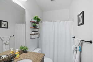 Full bathroom featuring vanity and curtained shower