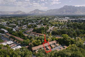 Aerial overview of property's location featuring property boundaries highlighted and a mountain backdrop