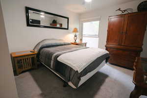 Bedroom with light carpet and a ceiling fan