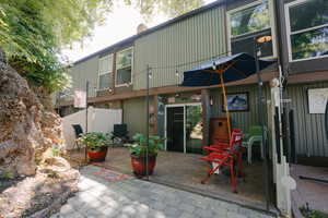 Back of house with a patio area and a chimney