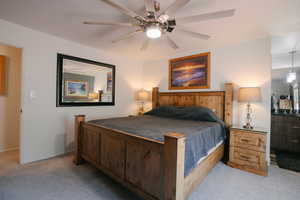 Bedroom with light carpet and ceiling fan