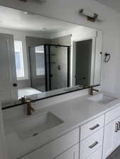 Full bathroom with a shower stall, a bath, double vanity, and a textured ceiling