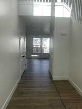 Hall featuring baseboards and dark wood-style floors