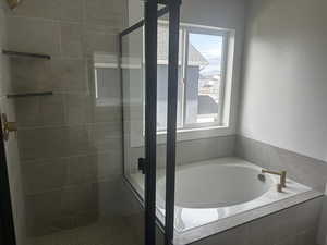 Full bath with a garden tub and a shower stall