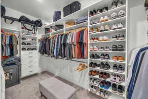 Spacious closet with light colored carpet