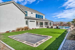 Back of house featuring stucco siding, a mountain view, a patio, and a fenced backyard