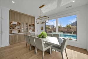Dining space featuring recessed lighting, a chandelier, and light wood finished floors