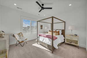 Bedroom with light carpet, ceiling fan, and recessed lighting