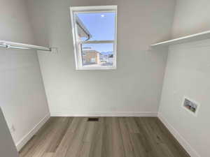 Laundry room with wood finished floors and hookup for a washing machine
