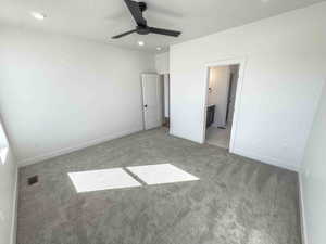 Unfurnished bedroom with recessed lighting, carpet, ceiling fan, and ensuite bathroom