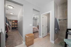 Primary Bathroom featuring an oversized bath, double vanity, recessed lighting, walki-in tile shower