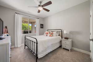 Bedroom featuring light carpet and ceiling fan