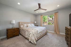 Primary Bedroom with recessed lighting, light colored carpet, a ceiling fan, and ensuite bathroom