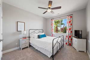 Bedroom featuring light carpet and ceiling fan