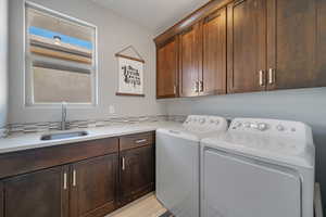 Washroom featuring cabinet space and separate washer and dryer