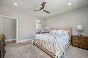 Primary Bedroom with recessed lighting, light colored carpet, a ceiling fan, and ensuite bathroom